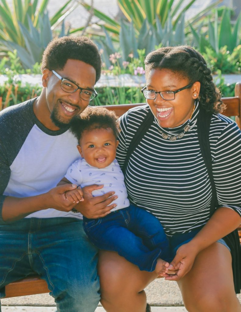 woman-in-black-and-white-striped-shirt-carrying-baby-in-blue-onesie-fwx91orbr6e